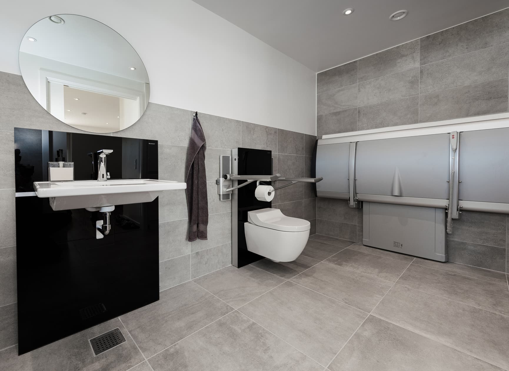 Accessible and flexible bathroom for Laura with shower and changing table